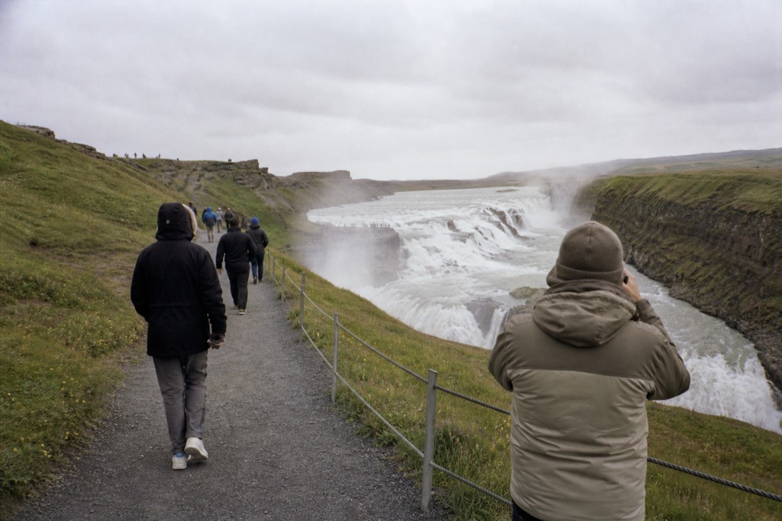 Visitors on the upper viewpoint path above Gullfoss waterfall near the visitor centre