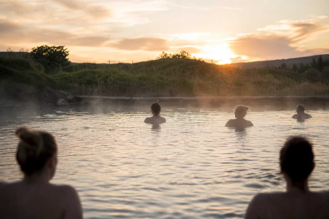 Steam rising off the Secret Lagoon geothermal pool near Flúðir at golden hour